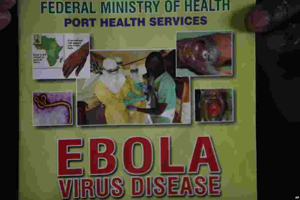 Nigeria health officials display a leaflet explaining the Ebola virus, at the arrival hall of Murtala Muhammed International Airport, in Lagos, Nigeria, Aug. 4, 2014. 