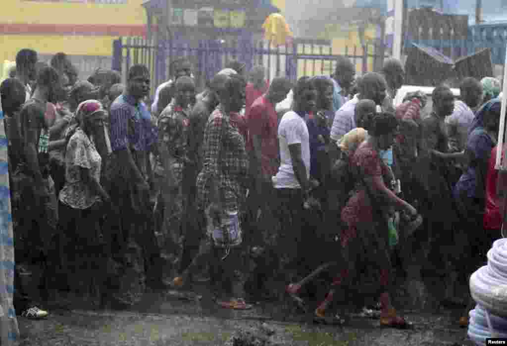 Catholic faithful walk in the rain during a procession reenacting the death of Jesus Christ, on Good Friday in Lagos, Nigeria, April 18, 2014. 