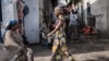 FILE - People walk through the Birere market in Goma, March 26, 2015. 