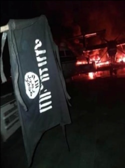An image distributed by al-Shabab after the attack on a military base in Kenya shows Somalia's al-Shabab militant group's flag, said to be at the Manda Bay Airfield in Manda, Lamu, Kenya, Jan. 5, 2020.