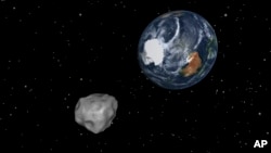 This image provided by NASA/JPL-Caltech shows a simulation of asteroid 2012 DA14 approaching from the south as it passes through the Earth-moon system on Feb. 15, 2013. The 45 meter object will pass within 17,000 miles of the Earth. 
