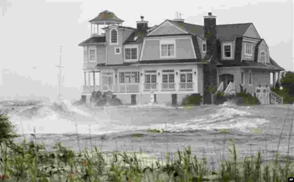 Rising water and waves from Hurrican Irene surround a beachfront house Sunday, Aug. 28, 2011 in Hampton Bays, N.Y. Forecasters said the storm remained capable of causing ruinous flooding with a combination of storm surge, high tides and 6 to 12 inches of