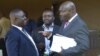 Roger Lumbala (R), a former member of parliament in the Democratic Republic of Congo who joined the M23 rebel group, chats with colleagues shortly after attending a peace talk meeting in Uganda's capital Kampala, January 11, 2013.