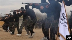 FILE - Members of Ahrar al-Sham brigade, one of the Syrian rebels groups, exercise in a train camp at unknown place in Syria, Nov. 29, 2013.