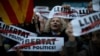 Demonstrators gather during a protest calling for the release of Catalan jailed politicians, in Barcelona, Spain, Nov. 11, 2017. Eight members of the now-defunct Catalan government remain jailed in an alleged rebellion case. The banners read in Catalan: "Freedom for the political prisoners."