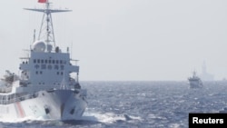 FILE - Ships of Chinese Coast Guard are seen near Chinese oil rig Haiyang Shi You 981 in the South China Sea, about 210 km (130 miles) off shore of Vietnam.