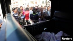 Warga berkerumun untuk melihat korban serangan bom di Jalan Juja, Nairobi, Kenya (31/3). 