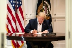President Donald J. Trump works in the Presidential Suite at Walter Reed National Military Medical Center in Bethesda, Maryland, Oct. 3, 2020, after testing positive for COVID-19. (Official White House Photo by Joyce N. Boghosian)