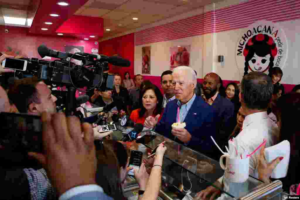 Democratic U.S. presidential candidate and former U.S. Vice President Joe Biden talks to reporters after ordering ice cream at La Michoacana during the state's Super Tuesday Democratic presidential primary election in Los Angeles, March 3, 2020.