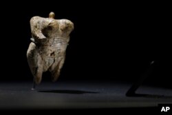 In this June 27, 2017 photo the 'Venus of Hohle Fels' figure is pictured in the Prehistory Museum in Blaubeuren, Germany. The 40,000 years old ivory Venus figurine is considered the oldest example of human figurative prehistoric art.