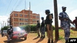 Policemen stand guard outside the Daily Monitor newspaper's offices in Kampala on May 20, 2013