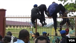 Warga Papua yang menghadiri Kongres Rakyat Papua ke-3 di Abepura melompati pagar saat polisi dan tentara dikerahkan untuk mengamankan situasi (19/10).