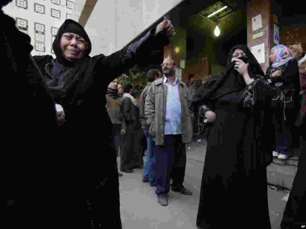 Egyptians react on February 2, 2012, after learning of the death of relatives during clashes at a soccer stadium in Port Said, Egypt a day earlier. (AP)
