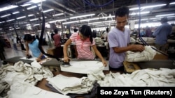 FILE - Workers iron and arrange clothing at a garment factory at Hlaing Taryar industrial zone in Yangon, March 10, 2010. (REUTERS/Soe Zeya Tun/File Photo)