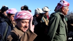 Kurdistan Iraqi regional government President Massoud Barzani arrives to support Kurdish forces as they head to battle Islamic State militants, on the summit of Mount Sinjar, in the town of Sinjar, Iraq, Dec. 21, 2014. 