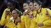 Members of the Brazil women's volleyball team show off their gold medals following a 3-1 win over the United States during the women's gold medal volleyball match at the 2012 Summer Olympics, Saturday, Aug. 11, 2012, in London. 