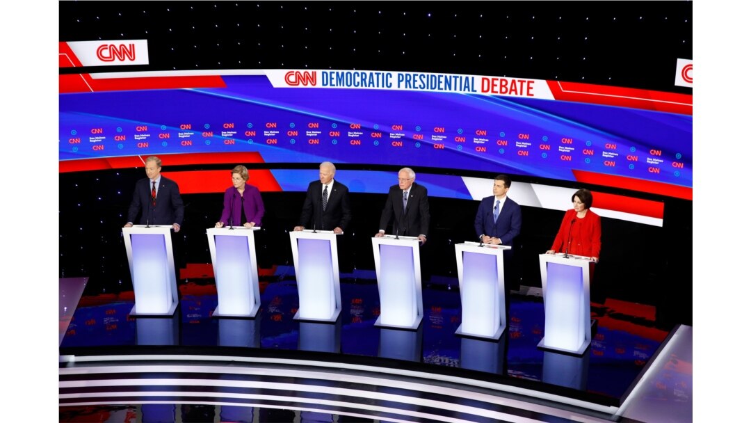 Democratic presidential candidates stand on stage during a Democratic presidential primary debate hosted by CNN and the Des Moines Register in Des Moines, Iowa, Jan. 14, 2020.