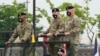 FILE - Incoming commander, Gen. Paul J. LaCamera, right, and outgoing commander, Gen. Robert B. Abrams, center, inspect the troops during a change-of-command ceremony in Pyeongtaek, South Korea, July 2, 2021.