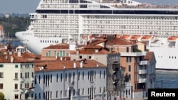 FILE - The MSC Musica cruise ship is seen in Venice lagoon June 17, 2012. Since the wreck of the Costa Concordia, environmentalists have stepped their efforts to have large cruise ships banned from the lagoon which surrounds the historic center of the canal city.