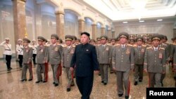 North Korean leader Kim Jong Un (C) visits the Kumsusan Palace of the Sun at midnight on Tuesday on the occasion of the 20th anniversary of the demise of President Kim Il Sung in this photo released by North Korea's Korean Central News Agency (KCNA) July 8, 2014.