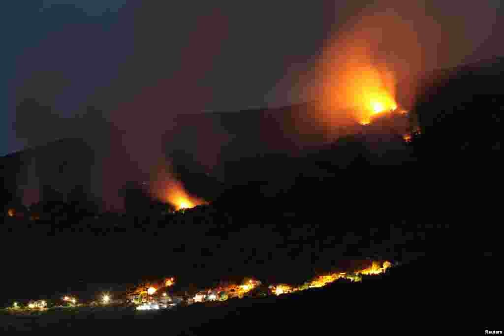 Forest fires can be seen on the Lustica peninsula near Tivat, Montenegro, Aug. 1, 2017.