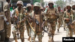 Djibouti soldiers serving in the African Union Mission in Somalia (AMISOM) patrol the south central town of Beledweyne in Somalia, May 9, 2013.