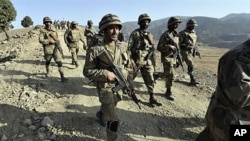 Pakistani troops patrol on a hill top post in Ladha, a town in the troubled tribal region of South Waziristan along the Afghan border, 17 Nov 2009