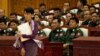 Aung San Suu Kyi walks to take her oath at the lower house of parliament in Burma.