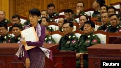 Aung San Suu Kyi walks to take her oath at the lower house of parliament in Burma.