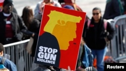 Participants hold up signs as students and gun control advocates hold the "March for Our Lives" demanding gun control after recent school shootings at a rally in Washington, 2018. 