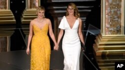 Greta Gerwig, left, and Laura Dern walk on stage to present the award for best documentary feature at the Oscars on March 4, 2018, at the Dolby Theatre in Los Angeles.
