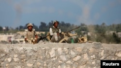 Egyptian soldiers keep guard on the border between Egypt and southern Gaza Strip, July 8, 2013, after armed men launched a series of attacks on security checkpoints in the North Sinai towns of Sheikh Zuweid and El Arish.