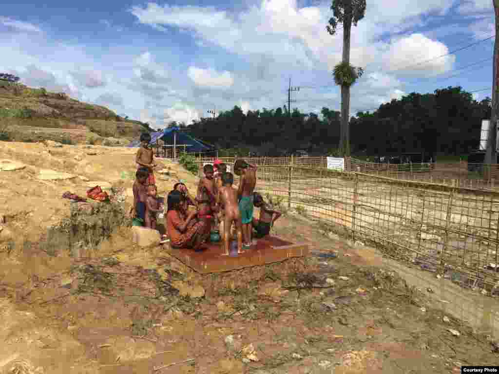 Children flock around a water pump a Rohingya refugee camp in Bangladesh. (Photo courtesy of Dr. Imran Akbar)