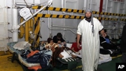 Injured men rest inside a Turkish ship carrying 250 wounded people from the besieged Libyan city of Misrata, at a port in Benghazi, Apr 3 2011
