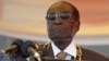 FILE: President Robert Mugabe waits to address crowds gathered for Zimbabwe's Heroes Day commemorations in Harare, August 10, 2015.