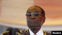 FILE - President Robert Mugabe waits to address crowds gathered for Zimbabwe's Heroes Day commemorations in Harare, August 10, 2015.