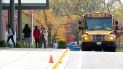 Students wear mask as they arrive their school for in-person learning at Holmes Middle School