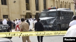 Polisi menjaga ketat lokasi di sekitar Masjid Imam Shadiq pasca ledakan bom saat salat Jumat, di daerah Al Sawaber, Kuwait (26/6).