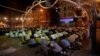 Men attend an evening mass prayer session called tarawih along a road to mark the fasting month of Ramadan in Karachi, Pakistan, May 27, 2017.