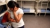 FILE - An unidentified Guatemalan woman and a child are seen inside a dormitory in the Artesia Family Residential Center, a federal detention facility for undocumented immigrant mothers and children in Artesia, New Mexico, Sept. 10, 2014.