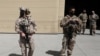 FILE - U.S. troops stand guard during a handover ceremony of A-29 Super Tucano planes from U.S. to Afghan forces, in Kabul, Sept. 17, 2020. 