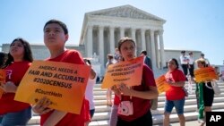 Demonstrators gather at the Supreme Court as the justices finish the term with key decisions on gerrymandering and a census case involving an attempt by the Trump administration to ask everyone about their citizenship status in the 2020 census June 27, 2019. (AP Photo/Applewhite)