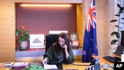 In this photo provided by New Zealand Prime Minister's Office, Prime Minister Jacinda Ardern talks with U.S. President-elect Joe Biden on phone at her office in Wellington, New Zealand, Nov. 23, 2020.
