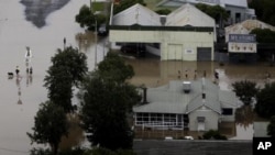 People wade through floodwaters in the town of Moree, Northern New South Wales, Australia, February 3, 2012.