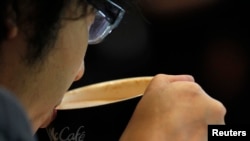 FILE - A man drinking coffee. 