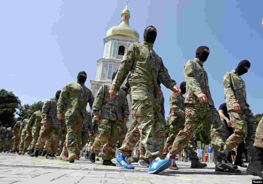 New volunteers of the Ukrainian self-defence battalion "Azov" walk in front of Saint Sophia Cathedral before taking their oath of allegiance to their country, in Kyiv, July 16, 2014.