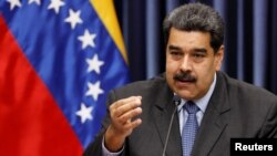 Venezuela's President Nicolas Maduro talks to the media during a news conference at Miraflores Palace in Caracas, Venezuela, Sept. 18, 2018.