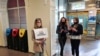 A supporter of Belarusian opposition blogger and activist Raman Pratasevich holding a placard reading 'I am/we are Raman Pratasevich waits for the arrival of a Ryanair flight after it was diverted to Belarus, at Vilnius Airport in Vilnius, May 23, 2021.