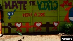 FILE - An AIDS mural is seen outside a clinic at Kumba Iron Ore, the world's largest iron ore mines in Khathu, Northern Cape Province, South Africa, Nov. 15, 2011.