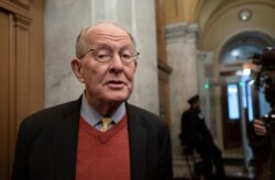 Republican Sen. Lamar Alexander of Tennessee talks to reporters in Washington, Jan. 31, 2020.